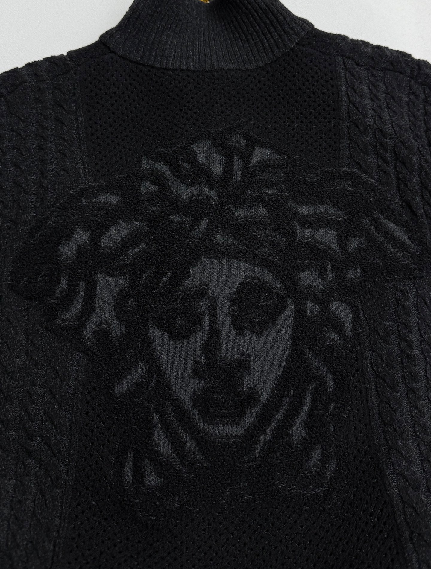 Versace black knit zip jacket with large lion-style graphic on chest