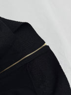 Versace black knit jacket sleeve with gold zipper track and ribbed cuff