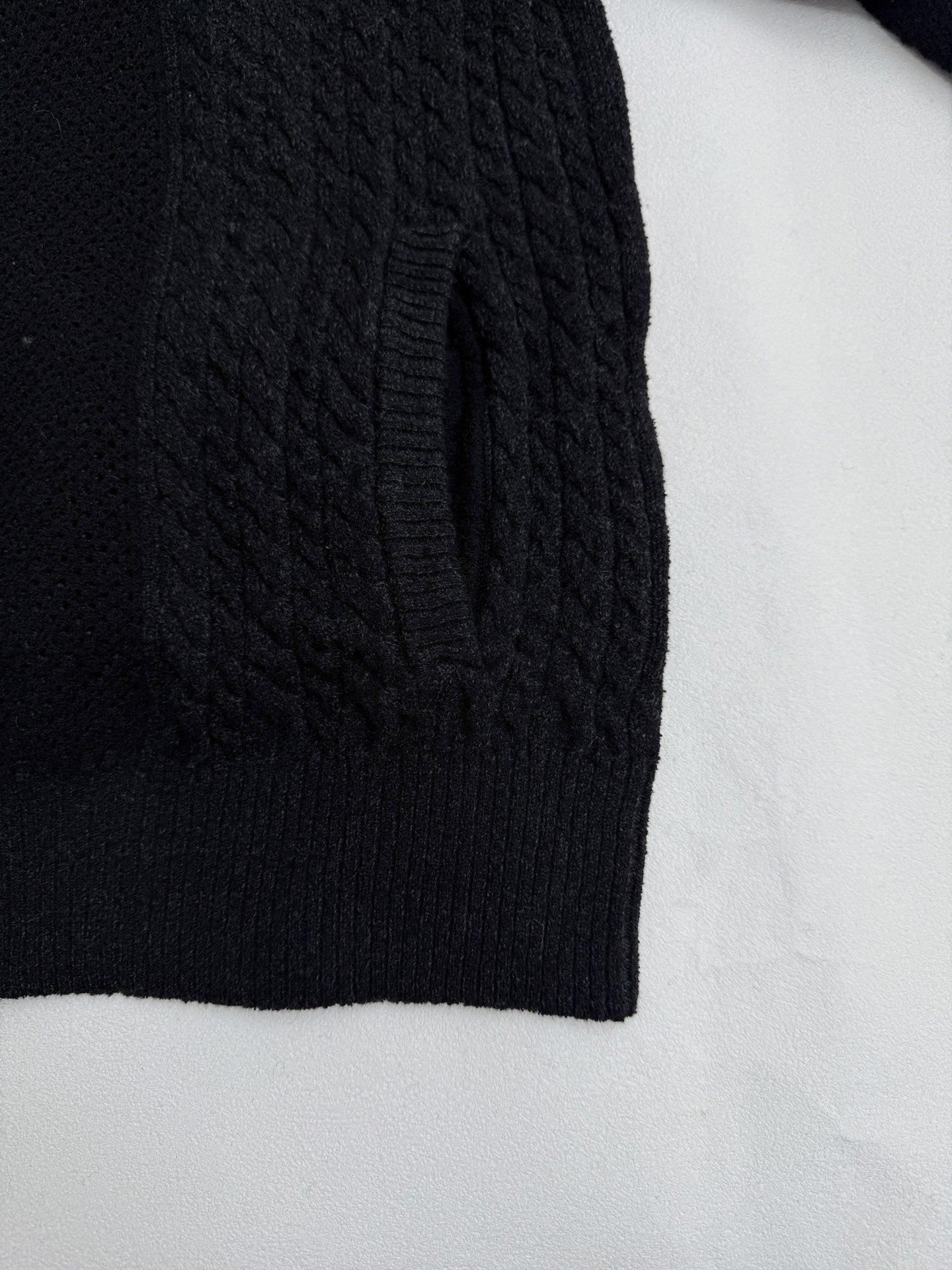 Versace black knit jacket side panel with ribbed hem and textured cable pattern