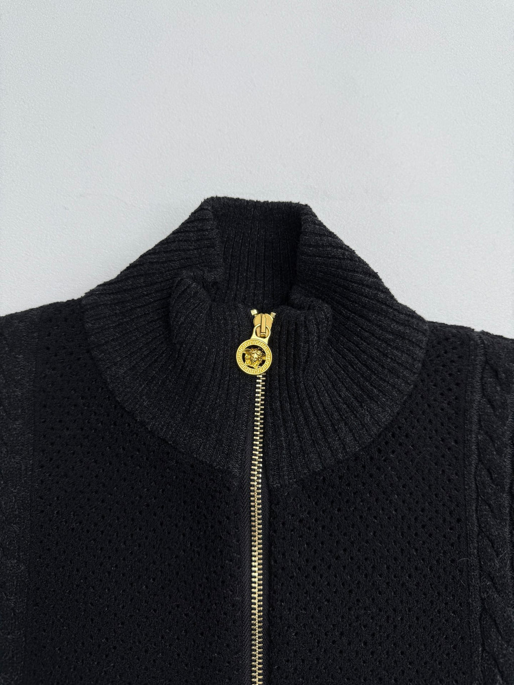 Versace black knit stand-collar jacket with gold zipper pull, textured knit detail