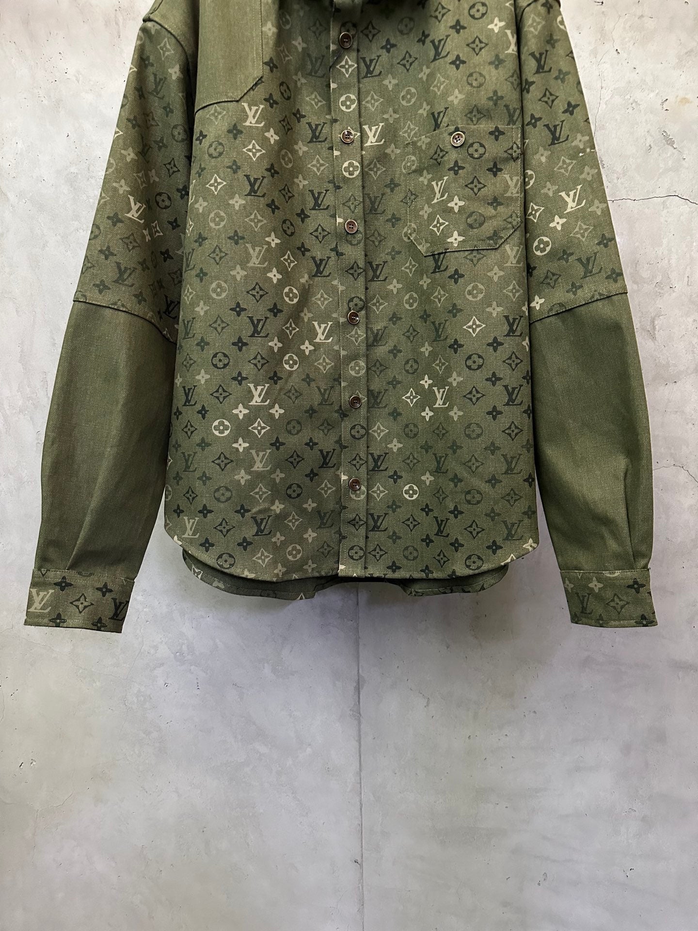Olive green monogram long-sleeve jacket, chest flap pockets and button front.
