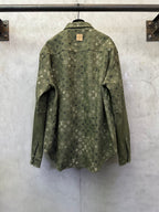 Olive green monogram long-sleeve button-up jacket, back view, flap pockets.