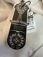 White hoodie with black and white hang tag attached to fabric collar