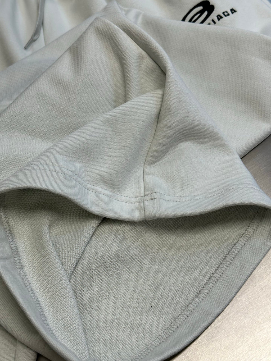 Balenciaga white pants with elastic waistband and visible front pocket seam
