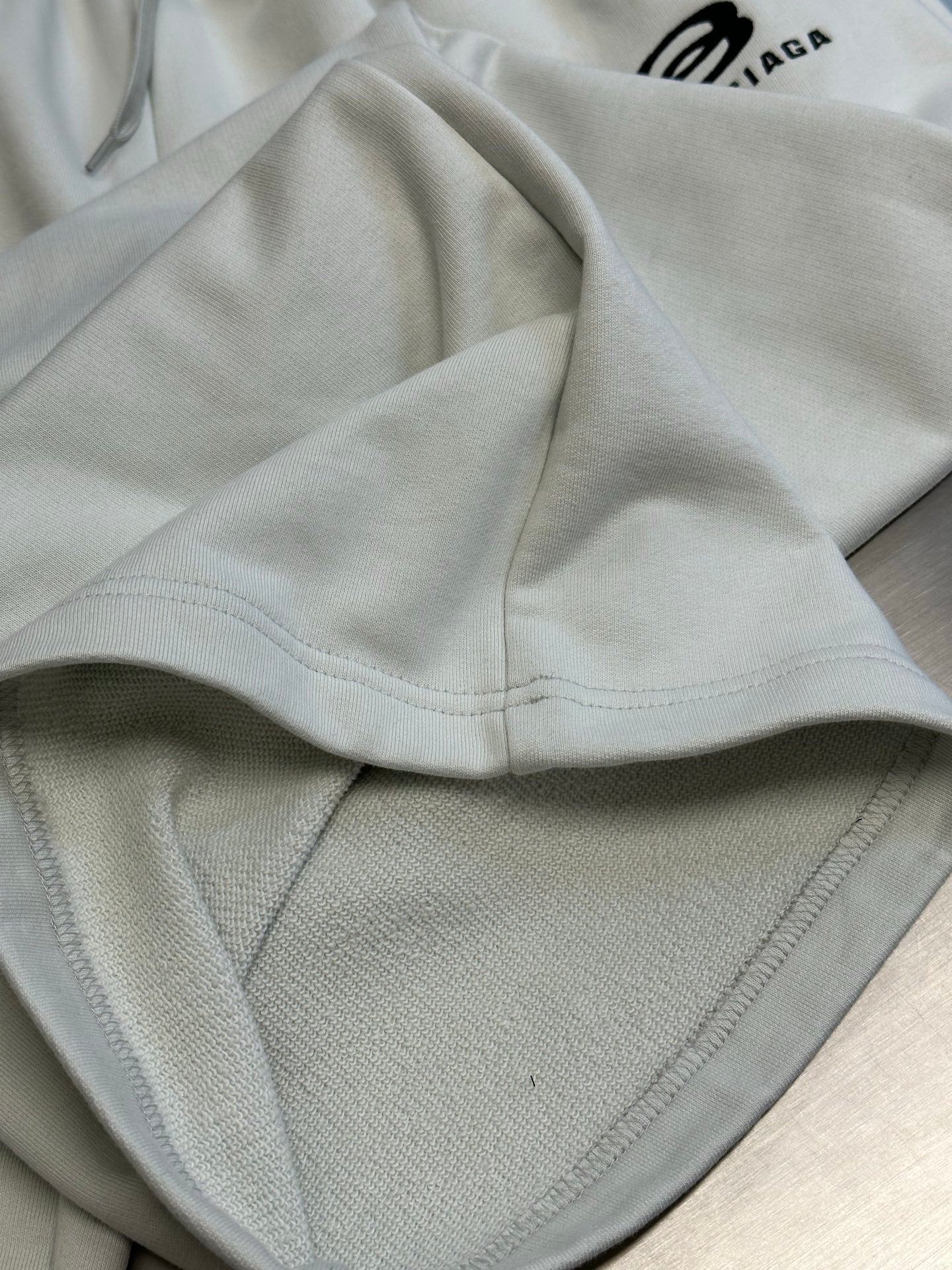 Balenciaga white pants with elastic waistband and visible front pocket seam