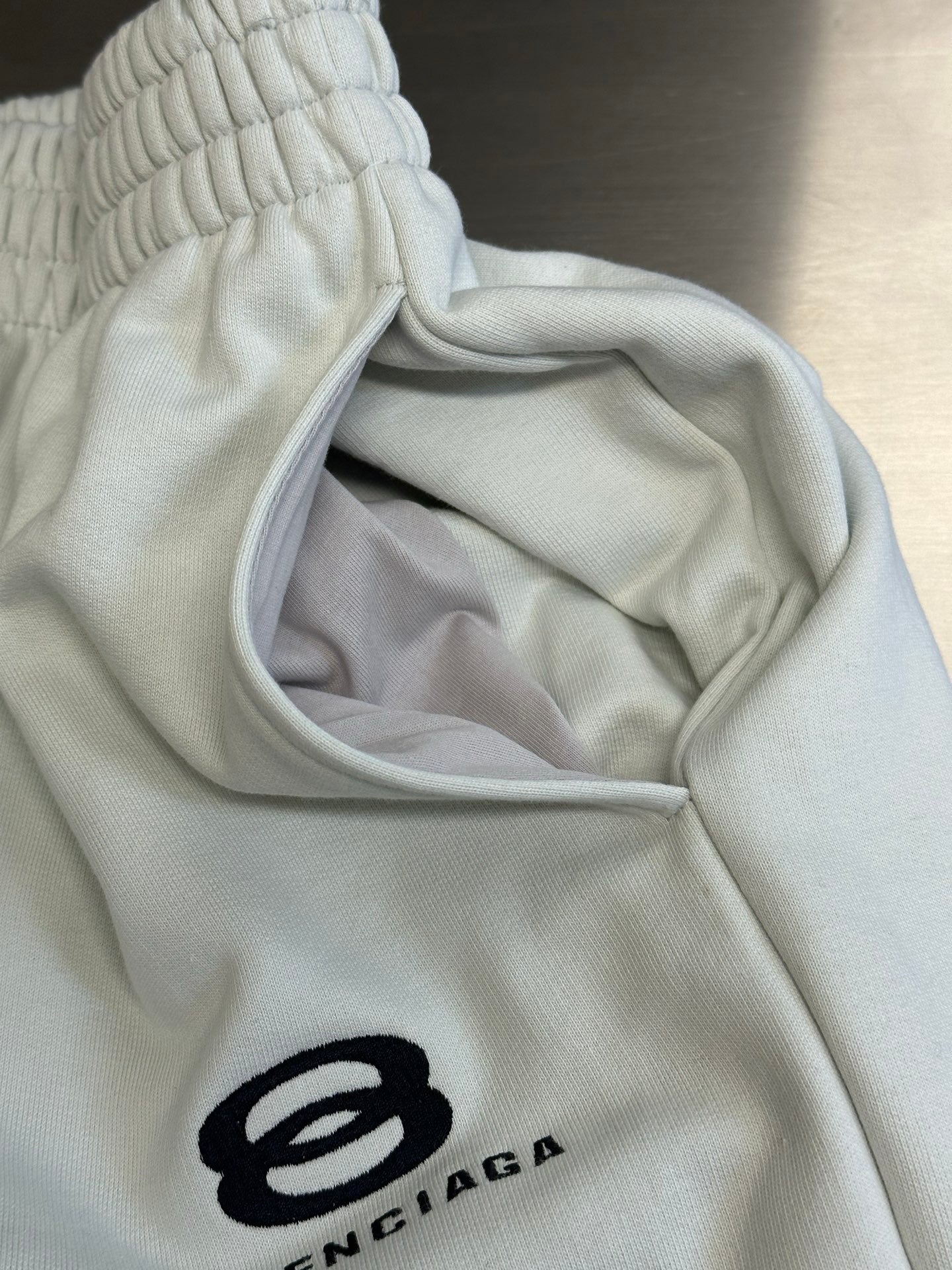 Balenciaga white pants with elastic waist and inner pocket lining view