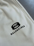 Balenciaga logo print on white fabric near the lower leg