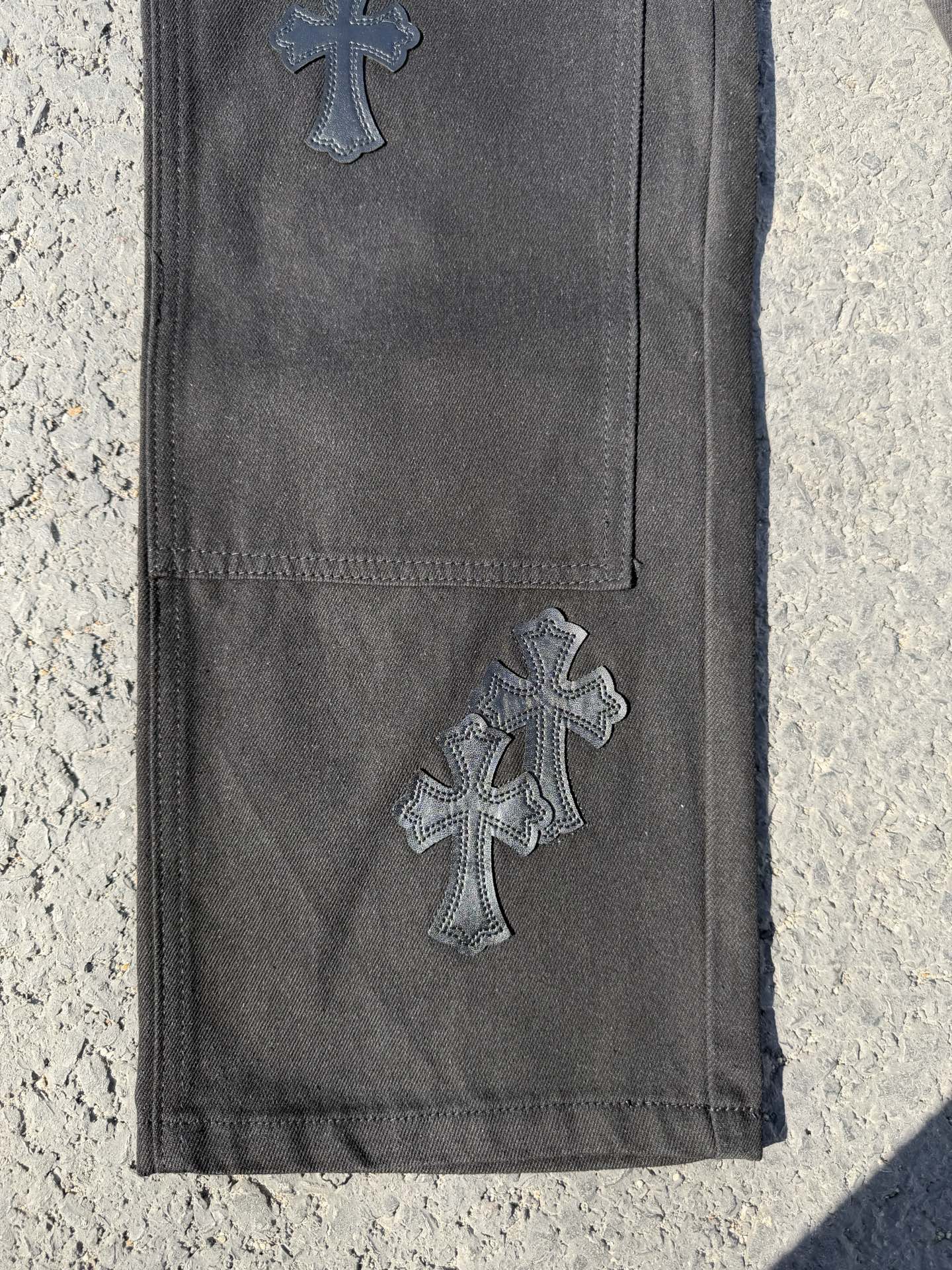 Chrome pants in dark gray with embroidered cross appliques on the leg