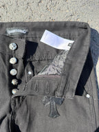 Black cargo pants with cross patch and interior tag on the waistband