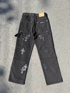 Black cargo pants with cross patches, drawstring tie, and small label at waistband