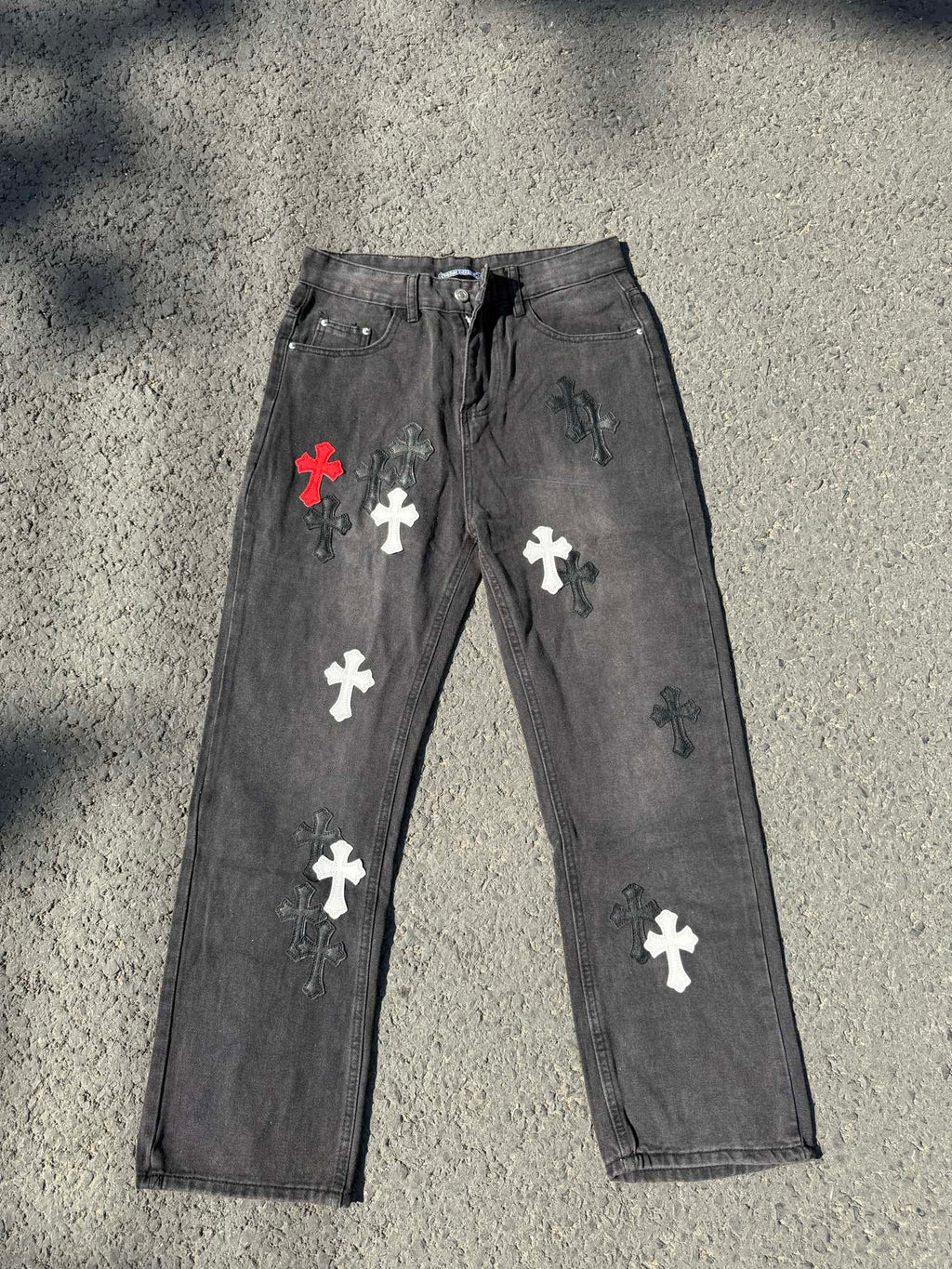Cross-patch denim pants, dark gray with red, white, and black cross graphics on legs