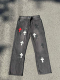 Cross-patch denim pants, dark gray with red, white, and black cross graphics on legs