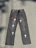 Cross-patch denim pants, dark gray with red, white, and black cross graphics on legs