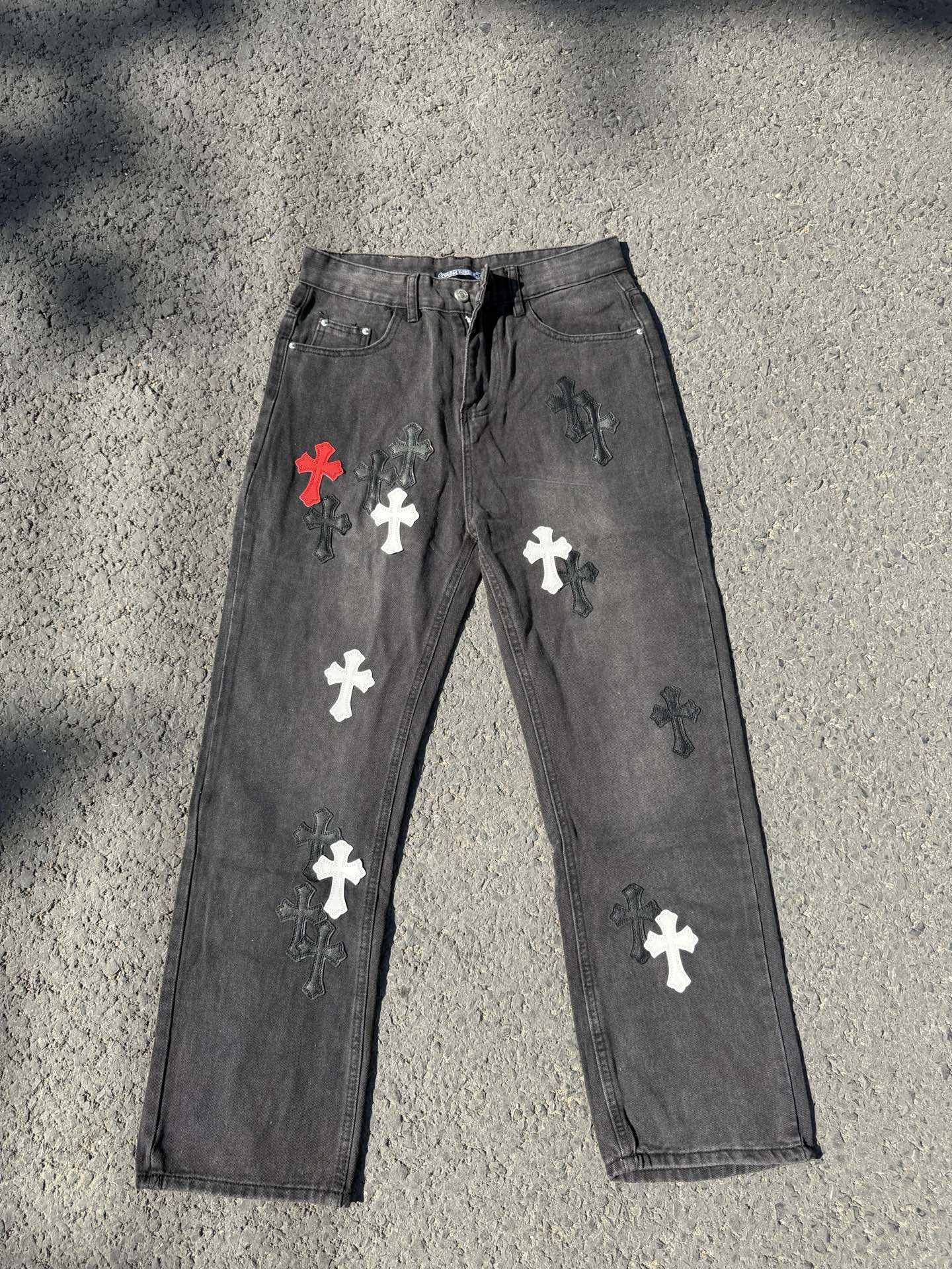 Cross-patch denim pants, dark gray with red, white, and black cross graphics on legs