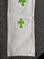 White denim pants leg with green cross patch print and smooth stitched front panel