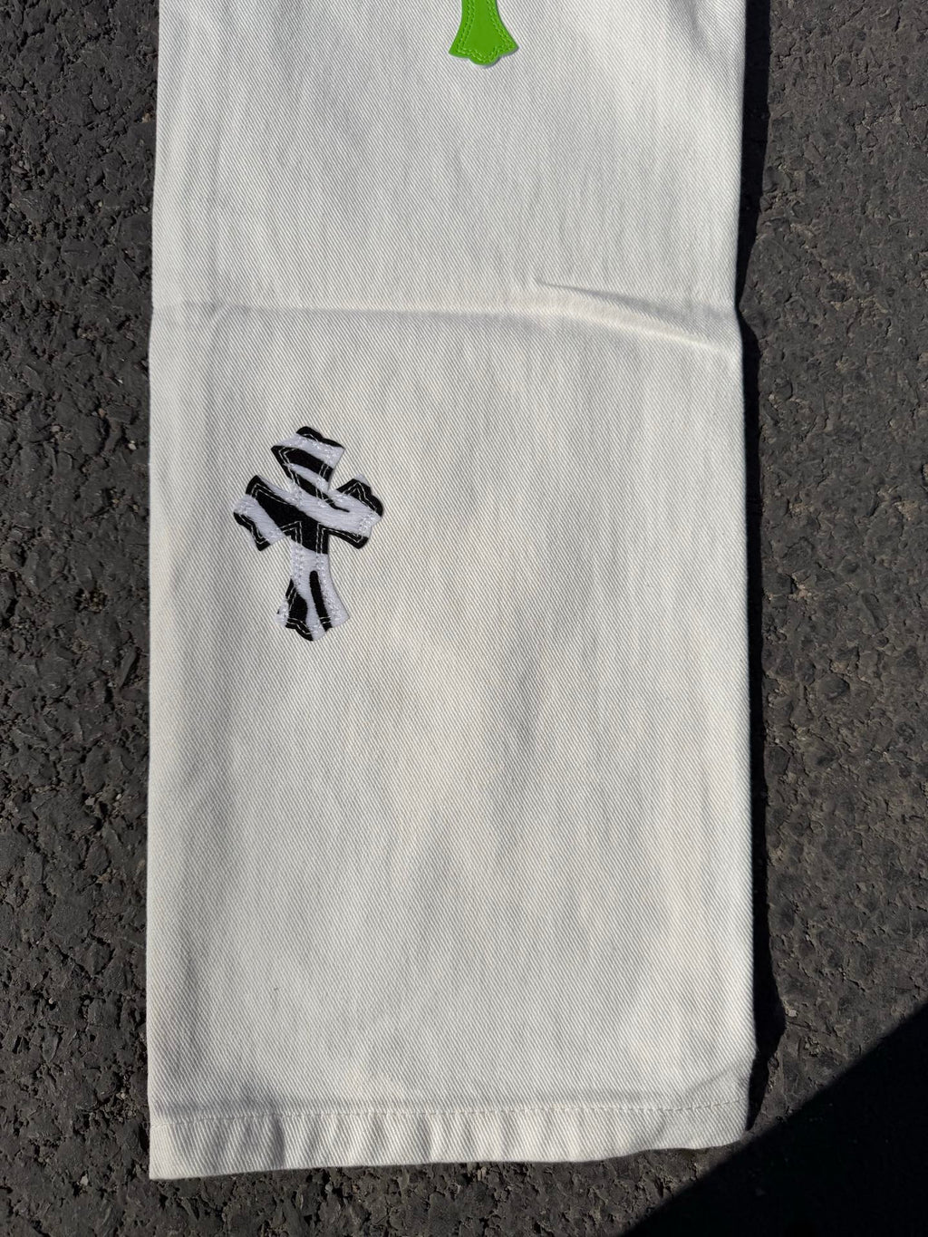White pants with black graphic print on leg