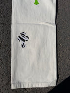 White pants with black graphic print on leg