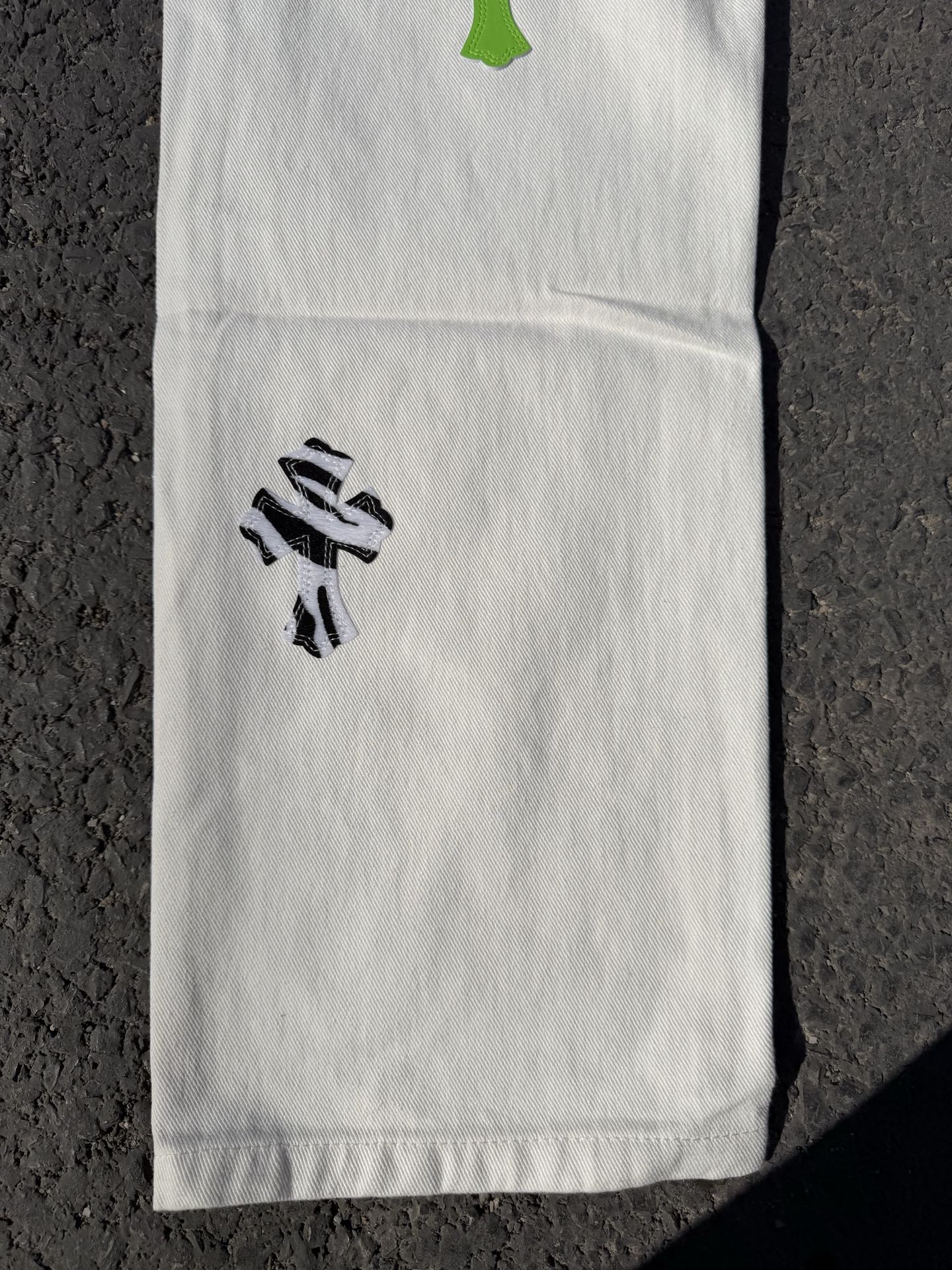 White pants with black graphic print on leg