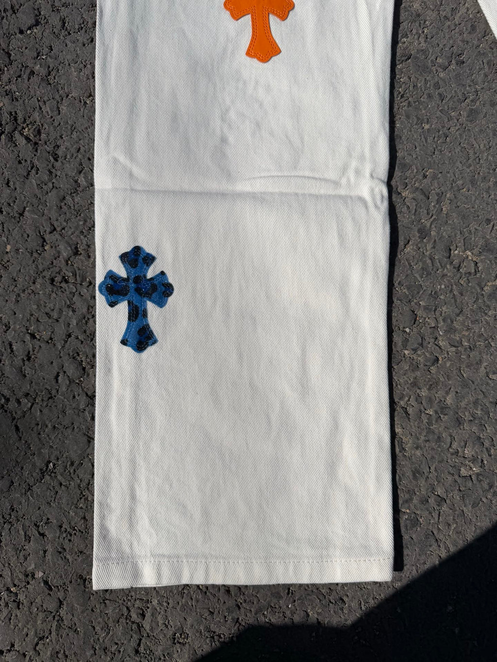 Chrome pants with white fabric and orange top cross patch with blue lower cross patch