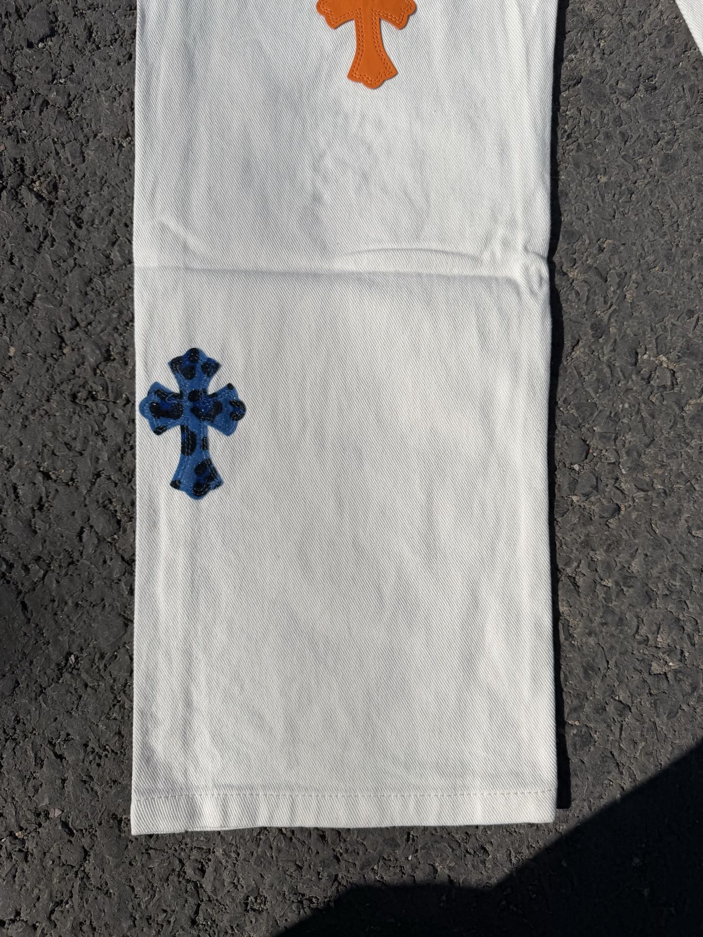 Chrome pants with white fabric and orange top cross patch with blue lower cross patch
