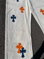 White pants with orange and blue cross prints and visible seam lines on leg