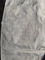 White denim pants with large embroidered floral snowflake pattern on the back