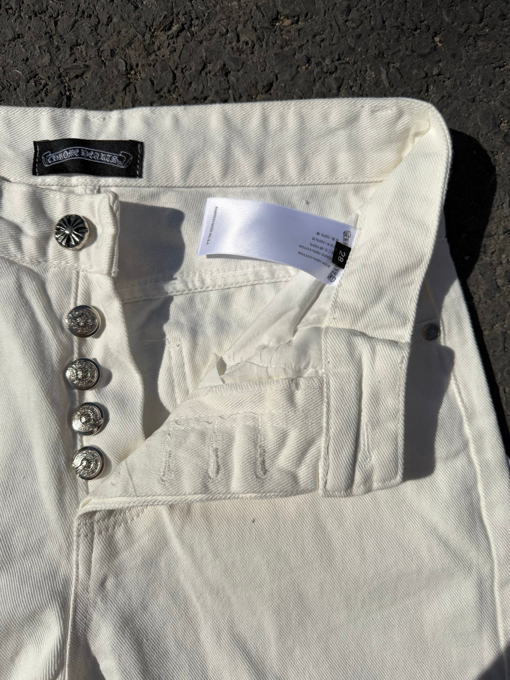 White denim pants with back yoke, patch pocket, and metal button hardware