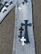 Light wash denim pants with vertical cross applique and navy bow detail