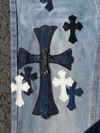 Light wash denim pants with ornate center graphic and white cross patches