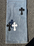 Light blue denim pants lower legs with dark and white cross patches