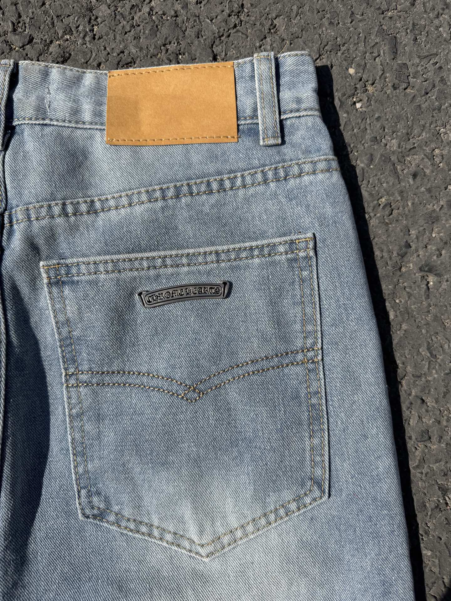 Light wash denim pants with back pocket and small logo label, button details