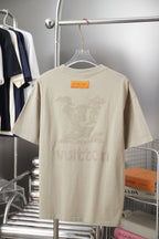 Beige Louis Vuitton T-shirt on hanger with rhinestone-style back graphic