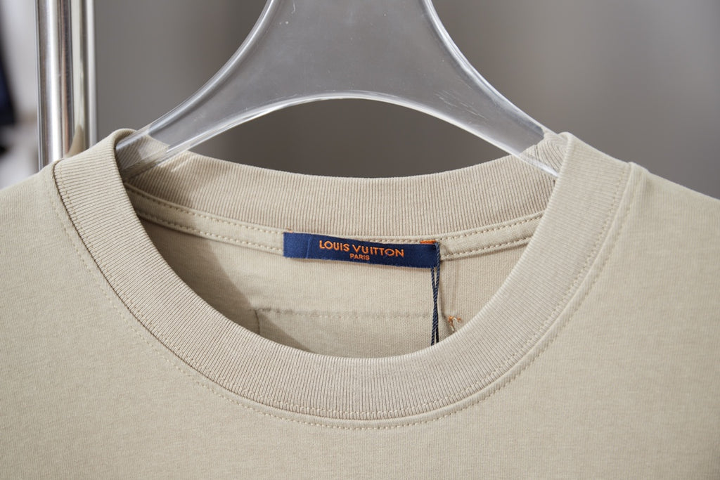 Beige Louis Vuitton T-shirt close-up of crew neck and inner brand label