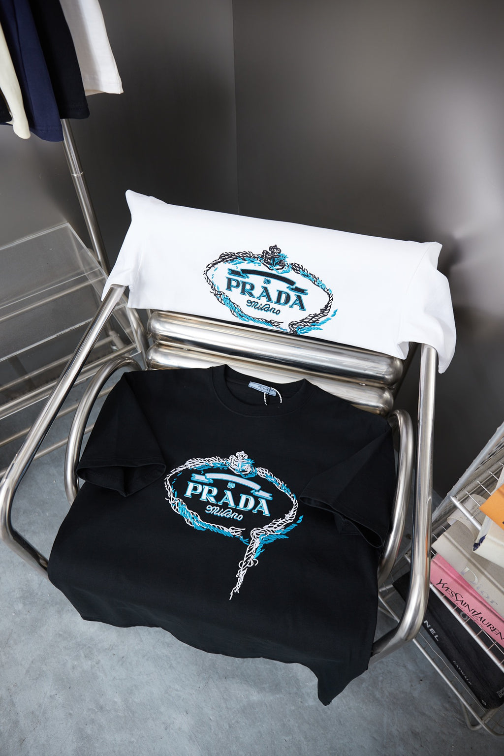 Folded white and black Prada T-shirts with embroidered PRADA Milano logos
