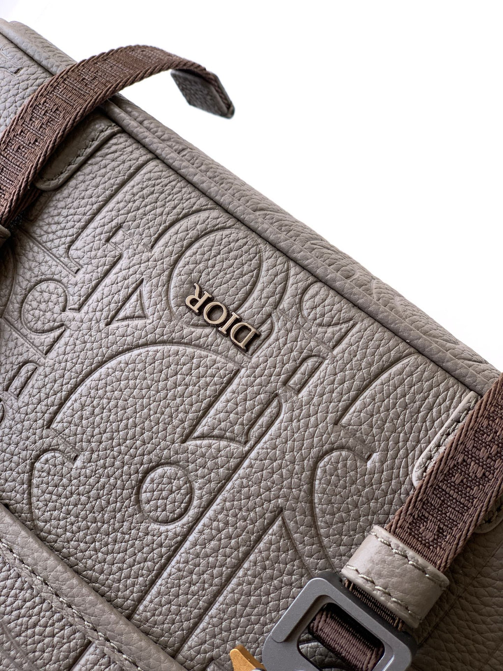 Dior taupe leather-look bag with embossed logo pattern and brown strap