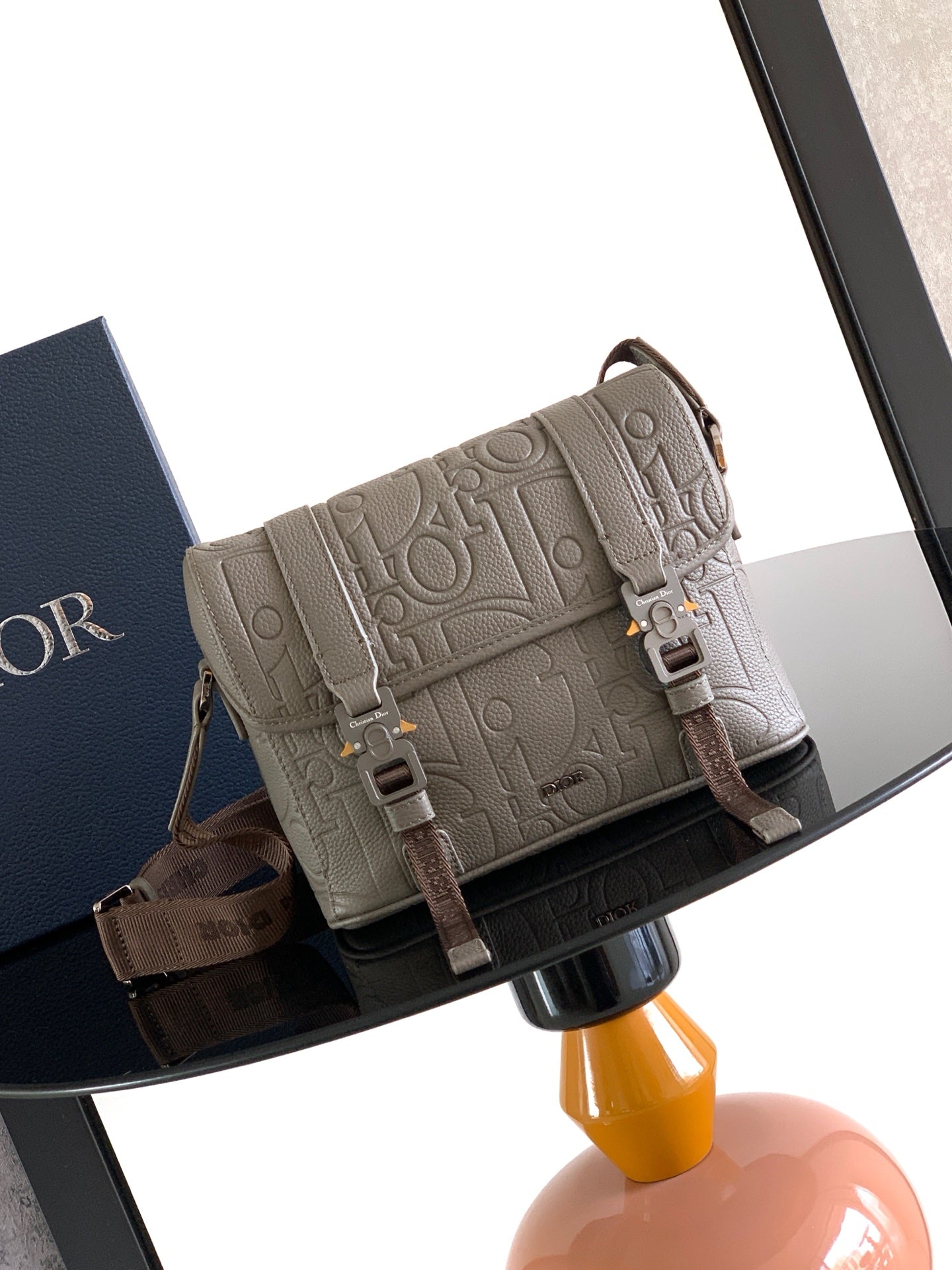 Dior embossed taupe crossbody bag with adjustable strap and front flap