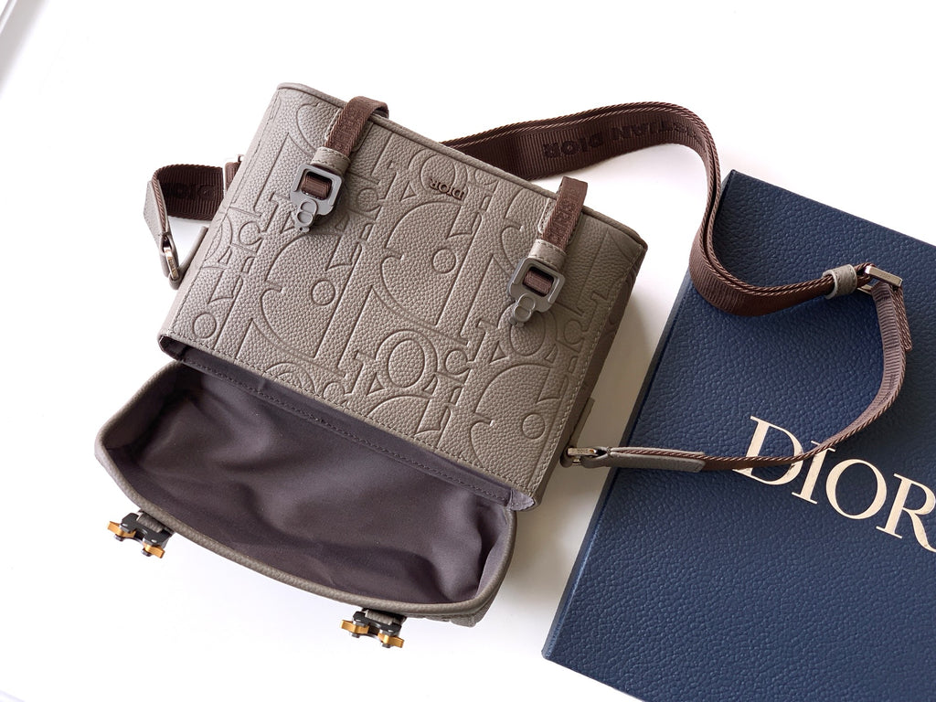 Dior taupe crossbody bag with top flap, zip opening, and brown adjustable strap