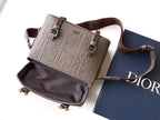 Dior taupe crossbody bag with top flap, zip opening, and brown adjustable strap