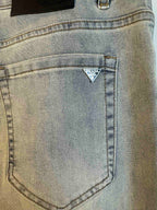 Light blue denim pocket with triangular Prada logo patch