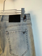 Light blue denim back pocket with triangular Prada logo patch