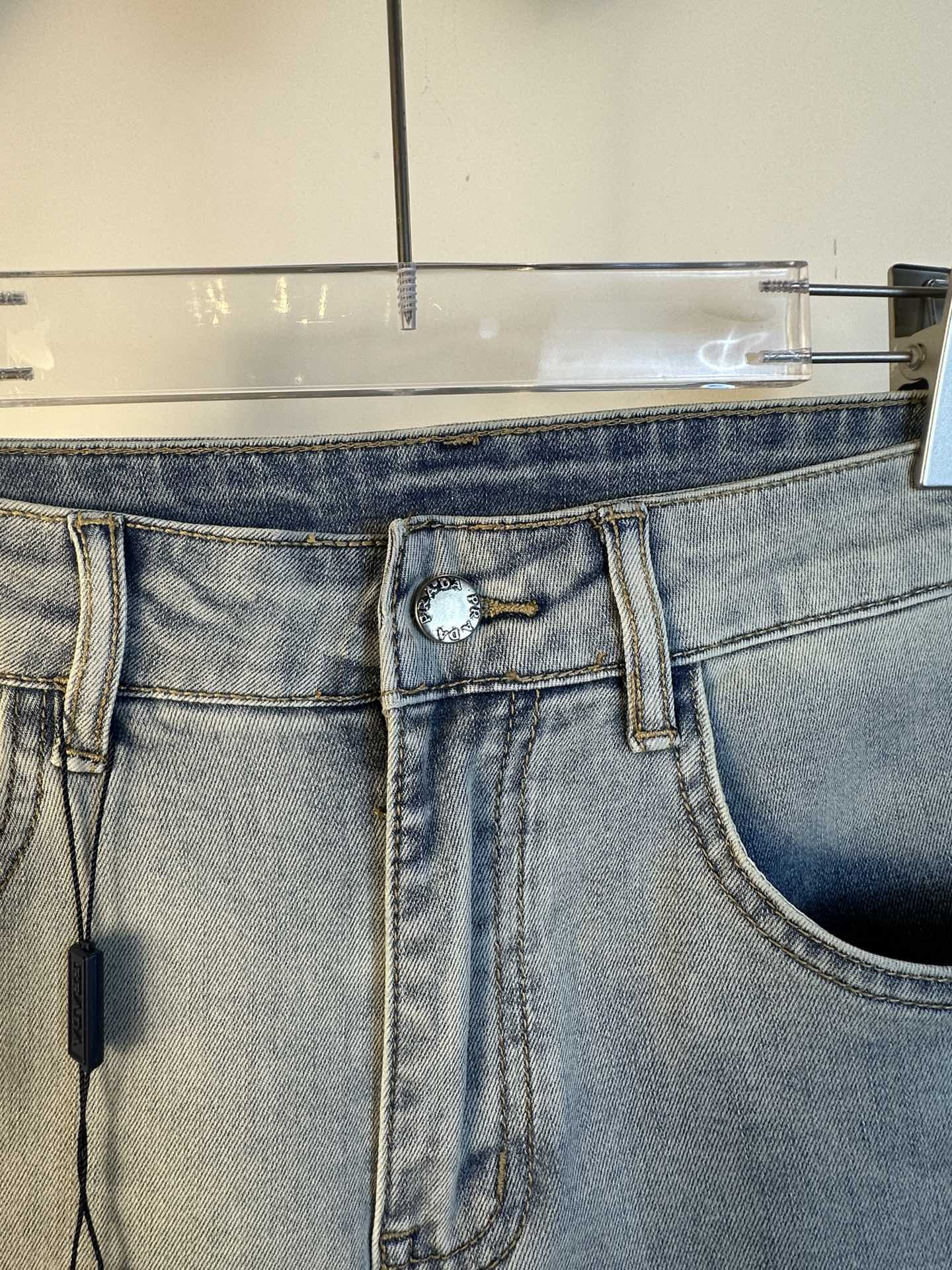 Light blue denim waistband with decorative ring detail and belt loops