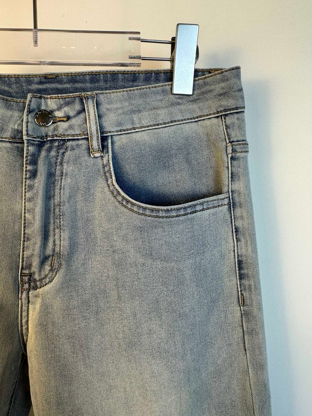 Light blue denim pants with curved front pocket and belt loops