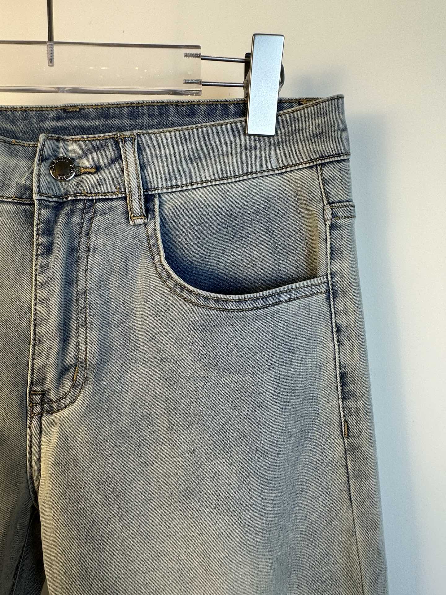 Light blue denim pants with curved front pocket and belt loops
