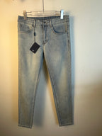 Light blue denim pants, full front view, with belt loops and hanging tag