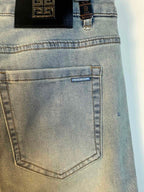 Light-wash denim jeans close-up of back pocket with small logo patch