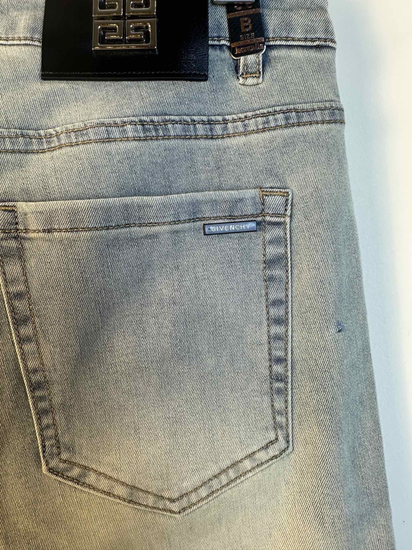 Light-wash denim jeans close-up of back pocket with small logo patch
