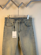 Givenchy light-wash denim jeans with five-pocket styling, belt loops, and hanging tag