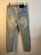 Light-wash denim jeans on a hanger with back pockets and belt loops