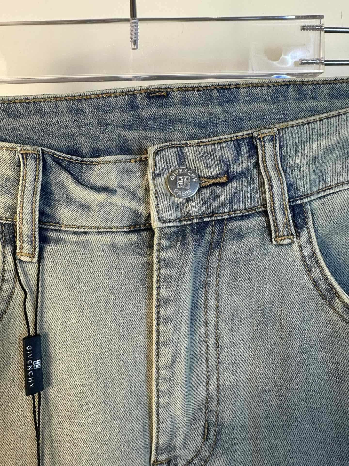 Light-wash denim jeans waistband and back yoke with two back pockets and hanging tag