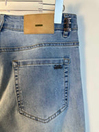 Louis Vuitton denim pants back pocket close-up with stitched edge and logo print
